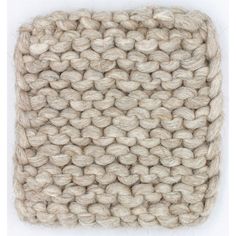 an image of a knitted square with white yarn on the bottom and beige wool in the middle