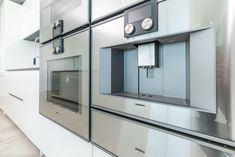 a kitchen with stainless steel appliances and white cabinets