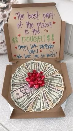 an open box with money in it and a red bow on the top that says, the best part of the pizza is the dough