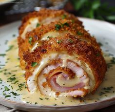 a white plate topped with meat covered in sauce