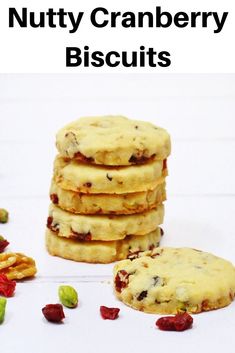 a stack of cookies with nuts and dried cranberries on the side next to it