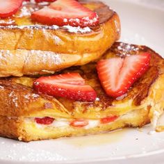 two pieces of french toast with strawberries on top