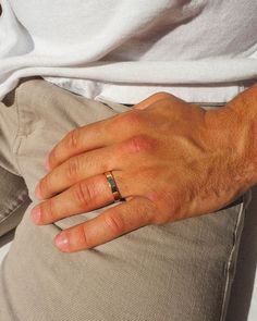 a man wearing a wedding ring sitting on his lap