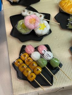 there are many sushi on the black trays