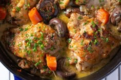 chicken with mushrooms and carrots in a skillet