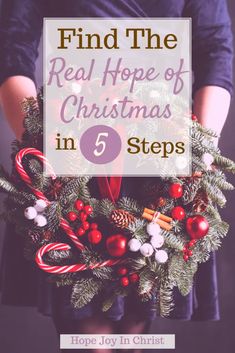 a person holding a wreath with candy canes on it and the words, find the real hope of christmas in 5 steps