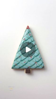 an origami christmas tree with a play button