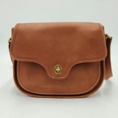 The Bag Shows Some Signs Of Wear, But Is In Very Good Overall Condition For Its Age. Dimensions: 11.5 X 8.75 X 3.25 Inches Formal Cognac Saddle Bag, Coach Leather Saddle Bag With Removable Pouch, Luxury Coach Shoulder Bag With Smooth Grain, Classic Leather Lined Crossbody Saddle Bag, Classic Leather-lined Crossbody Saddle Bag, Elegant Saddle Bag For Everyday Use, Classic Coach Daily Flap Bag, Classic Coach Flap Bag, Classic Coach Saddle Bag With Removable Pouch