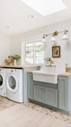 a washer and dryer are in the middle of a room with a rug on the floor