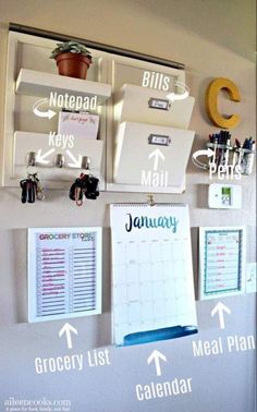 an organized calendar hangs on the wall with magnets and clipboards attached to it