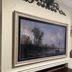 a painting hanging on the wall above a fireplace