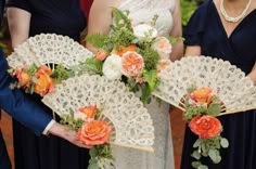 the bridesmaids are holding their bouquets with orange and white flowers on them