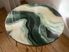 a round table with green and white marble on it