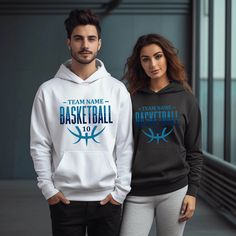 two people standing next to each other wearing matching hoodies with basketball logos on them