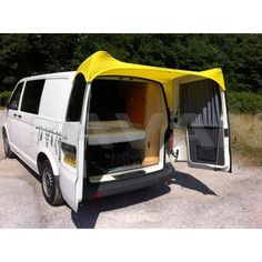 a white van with its doors open and the back door opened to show it's interior