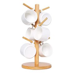 a wooden rack with white cups and saucers on it's sides, in front of a white background