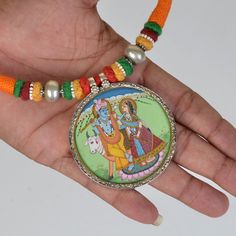 Weight- 28.5 Grams Approx 2 In 1 Pendant Necklace Double side Silver Hand Painting Pendant Necklace One side God Ganesha Painting & back side God Radha Krishna Painting Hindu Indian Necklace Handmade Pendant 92.5 Silver one side Ganesha Pendant Miniature Painting and second side Hindu God Radha Krishna Hand Painting, Glass Framed Pendant With Silver Lock Primary Color of Pendant is Silver. Necklace Thread Colour- Red Orange and Green beautiful combination of colour. Weight of Necklace- Approx 80 Gram Covered by silver and glass. Used natural water colours on paper sheet. It's a totally handmade hand Painted Miniature Painting Hindu Deity Pendant from Rajasthan. Artistic Jewelry With Artistic Design For Festivals, Artistic Silver Jewelry For Festivals, Artistic Multicolor Jewelry For Wedding, Artistic Jewelry For Jewelry Making And Festivals, Artistic Multicolor Wedding Jewelry, Hand Painted Jewelry For Festivals, Handmade Multicolor Temple Necklace For Puja, Multicolor Necklaces For Puja, Traditional Hand Painted Pendant Jewelry