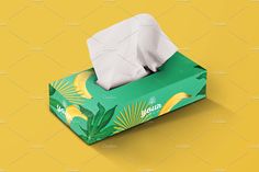 a tissue box mockup on a yellow background with tropical leaves and banana print,