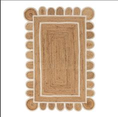 an area rug with circles and fringes on the bottom, in beige tones against a white background