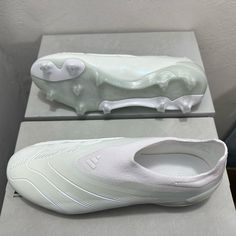 a pair of white shoes sitting on top of a counter