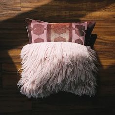 a decorative pillow is placed on a wooden surface