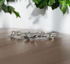 Leaf and Vine Twig Bangle Bracelet in Sterling Silver - Polished or Oxidized- by DV Jewelry Designs This bangle has 11 hand sculpted leaves with twig texture and vines plus tiny buds. The perfect everyday bracelet, beautiful worn alone or when stacked in multiples. Bangle Size:  Small- 2.25 (ID) inches in diameter Medium- 2.5 (ID) inches in diameter Large- 2.75 (ID) inches in diameter Thickness: 3mm to 6mm at widest point. Note: Made to Order, please allow 3-4 weeks to ship. This is for (ONE) Leaf & Twig Bangle. Multiple Bangles are available to purchase. Ships in a Black Velvet Bag with DV Tag Materials: Sterling Silver with Oxidation or without Oxidation Everyday Bracelet, Velvet Bag, Schmuck Design, Jewelry Designs, Bangle Bracelet, Bangle Bracelets, Vines, Jewelry Bracelets, Etsy Accessories