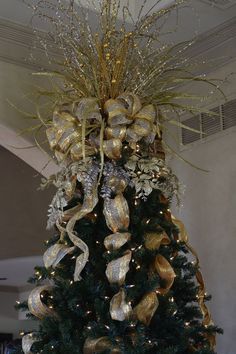 a christmas tree with gold and silver decorations