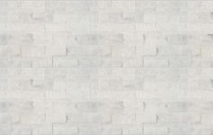 a white brick wall textured with cement blocks