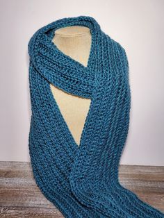 a blue knitted scarf on top of a mannequin