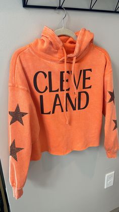 Ladies, Bright orange Browns Hoodie with sparkle brown star sleeve detail. Waist length crop sweatshirt; cleveland Browns crop sweatshirt Relaxed Fit Sweatshirt With Star Print For Fall, Relaxed Fit Star Print Sweatshirt For Fall, Casual Star Print Sweatshirt For Loungewear, Trendy French Terry Tops For Winter, Oversized Fall Sweatshirt With Star Print, Relaxed Fit Star Print Top For Fall, Fall Star Print Hoodie Sweatshirt, Star Print Hoodie Sweatshirt For Fall, Trendy Fall Sweatshirt With Star Print