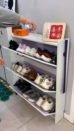 a person standing next to a shelf filled with shoes