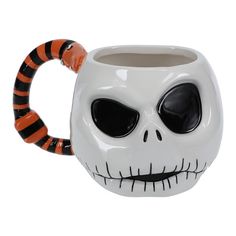 a white mug with black and orange stripes on it's handle, decorated like a skeleton