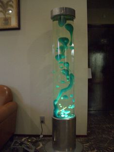 a large glass vase sitting on top of a metal stand