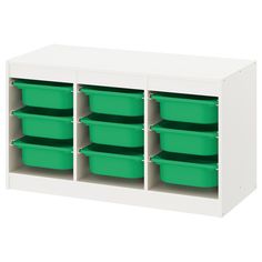 a white shelf with green bins on it