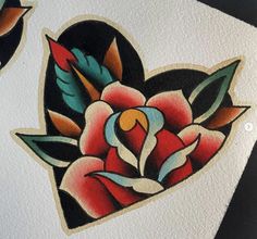 two heart shaped tattoos on white paper with red and blue flowers in the middle one has a bird