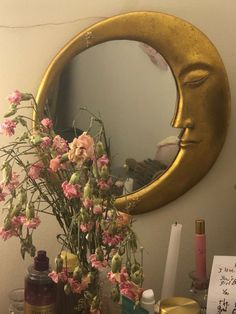 a vase with flowers in front of a mirror