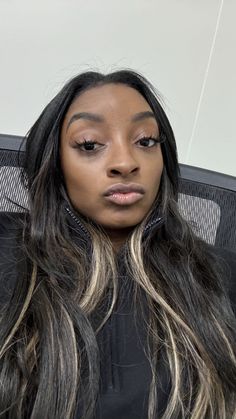 a woman with long hair sitting in an office chair