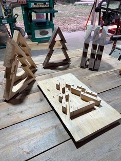 several pieces of wood sitting on top of a wooden table next to a sawhorse