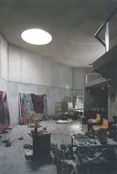 an empty room with many pieces of art on the floor