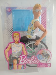 a barbie doll in a plastic box with a man riding a bike on it's back