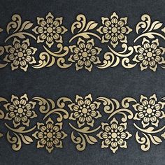 two pieces of gold lace with flowers on black paper, one is cut in half and the other has an intricate design