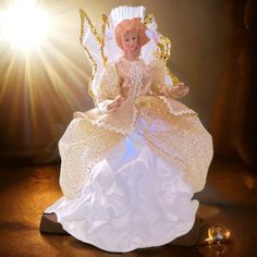 an angel figurine sitting on top of a table next to a light bulb