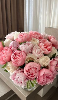 a vase filled with pink and white flowers