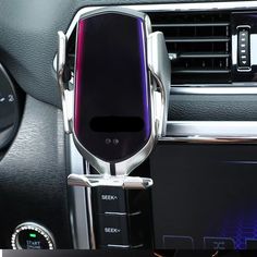 an air vent in the middle of a car with a phone holder attached to it