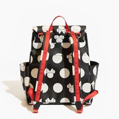 a black and white polka dot backpack with red straps on the front, featuring mickey mouses