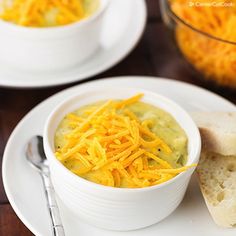 two white bowls filled with food on top of a table