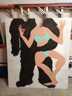 a painting of a woman in a bathing suit hanging on a wall next to a gorilla