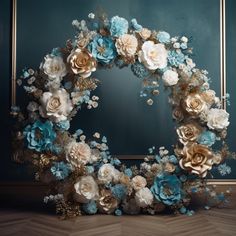 a blue and white wreath with flowers on it in front of a mirror that is hanging on the wall