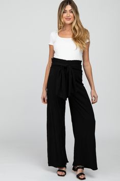 A pair of lightweight maternity pants featuring a smocked elastic waistband, an adjustable front tie and wide hem. The Black High Waist Tie Front Wide Maternity Pants is perfectly bump-friendly! Maternity Pants, Pants Large, Black High Waist, Pink Blush Maternity, Waist Pants, Pull On Pants, Waist Tie, Maternity Clothes, Empire Waist