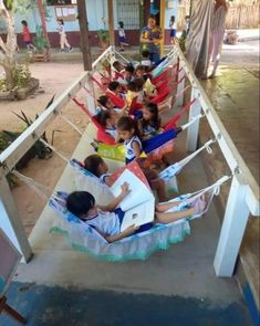 a group of children sitting in hammocks on a porch next to each other